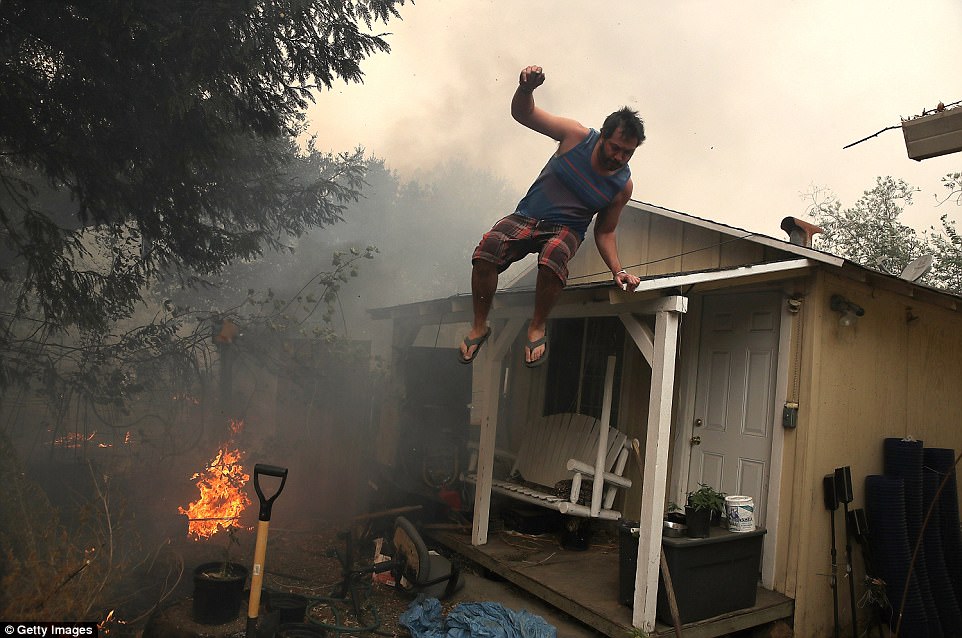 A resident rushes to save his home in Glen Ellen